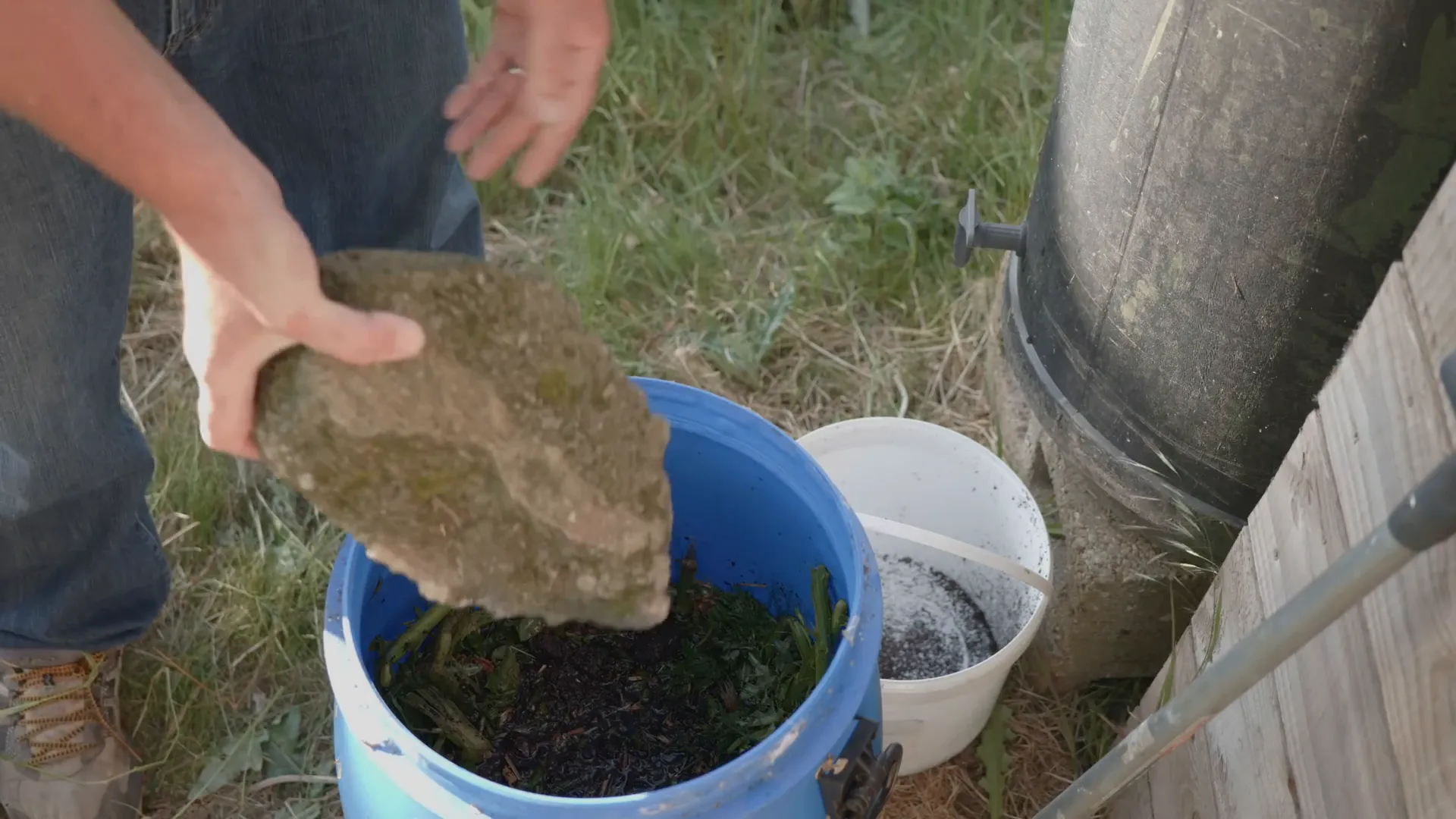 Bucket with submerged plant material fermenting