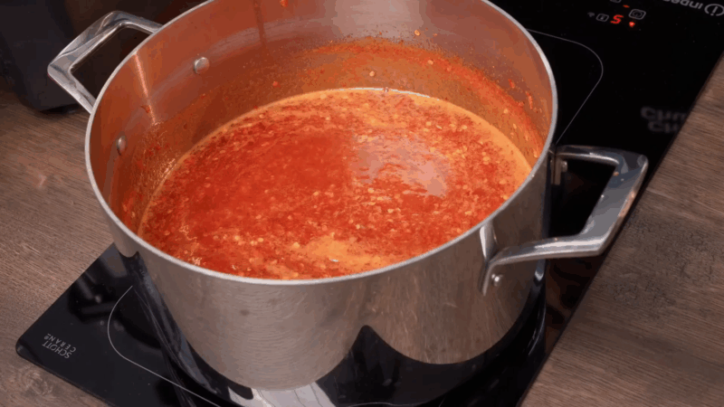 Chilli jam simmering in a large pan