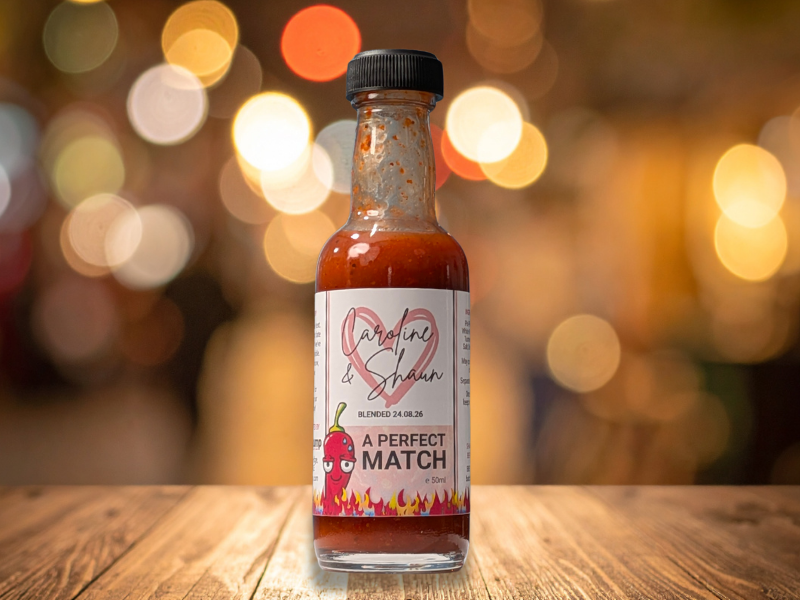 Chilli Wedding Favours: Handcrafted & Personalised 7 ChilliChump wedding favour 50ml hot sauce bottle with pink hearts and personalised couple names on the label