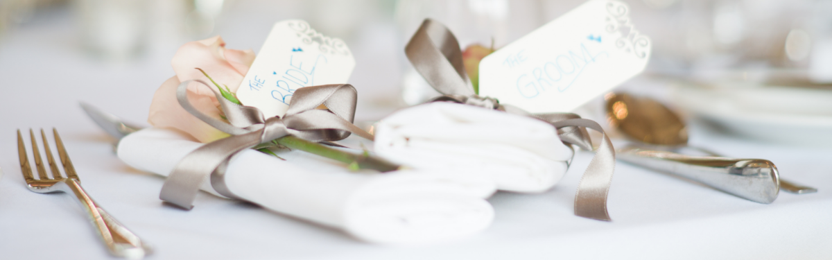 Chilli Wedding Favours: Handcrafted & Personalised 2 Selection of personalised chilli wedding favours including hot sauce bottles and spice tins displayed on a decorated wedding table setting