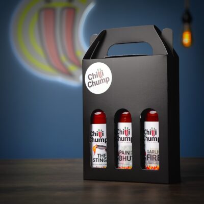 ChilliChump Super Hot Hot Sauce Gift Box in a black carry box with handle, angled view showing The Sting, Pain in the Bhut and Garlic Fire bottles inside.